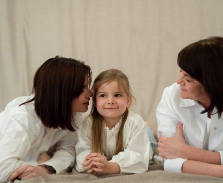 Three generations of women smiling together, symbolizing familial love and connection.