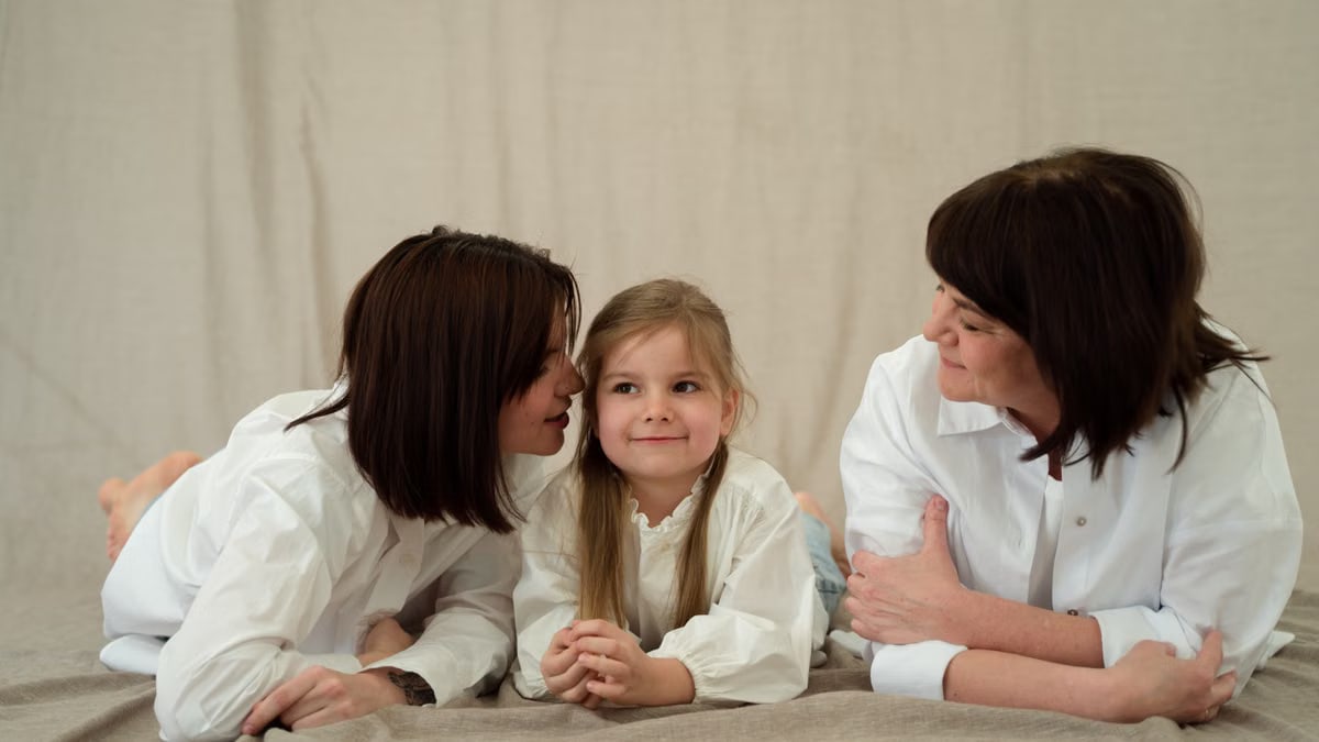 Three generations of women smiling together, symbolizing familial love and connection.